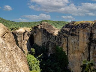 Panoramic view of Meteora monastery on the high rock and road in the mountains, Greece