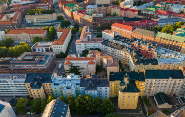 Aerial close view to Helsinki central residental area. Multistory buildings. Colorful roofs in Scandinavia. Finland sunset