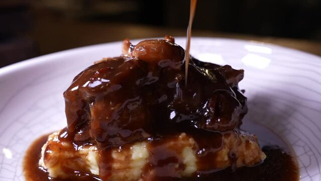 Potato puree served with oxtail glaze and topped with meat gravy