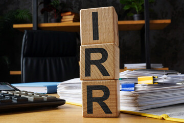 Wooden cubes with abbreviation IRR internal rate of return. - obrazy, fototapety, plakaty