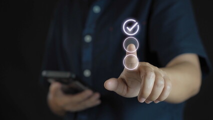 Closeup of hand thumb up with virtual correct sign or tick mark for approve quality assurance and guarantee concept.