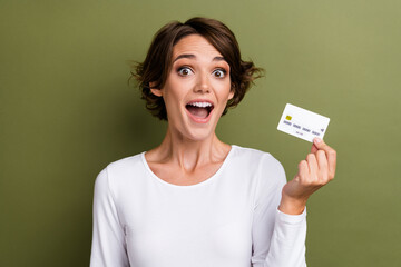 Photo portrait of pretty young girl hold excited credit card bank client wear trendy white outfit...