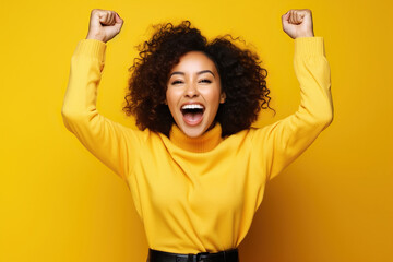 Photo of overjoyed cheerful woman dressed stylish clothes celebrate success raise hands fists isolated on yellow color background