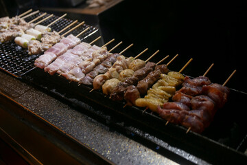Grilled yakitori chicken skewers at an Izakaya restaurant in Omoide Yokocho street in the Shinjuku district of Tokyo.