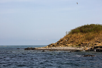 Fototapeta na wymiar View of the coast of an island from the sea
