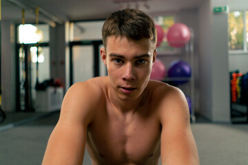 Obraz premium portrait of a tired sweaty sportsman resting in the gym after a hard workout motivation
