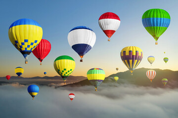 Bright hot air balloons flying over misty mountain at sunrise