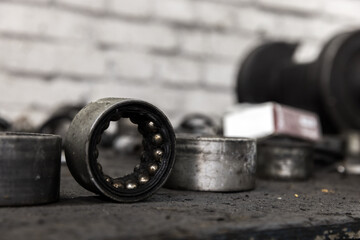Old used bearings on a desk in a car repair shop, close up