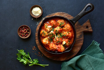 Meatballs with rice in tomato sauce. Top view with copy space. © lilechka75