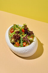 Salad with asparagus on a bright background.