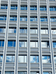 reflection of the sky with clouds in the windows of houses © Svitlana