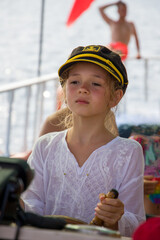 cute little girl in sailor hat looks forward