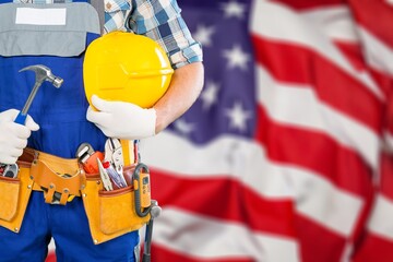 Professional male labour with tools equipment at USA flag background