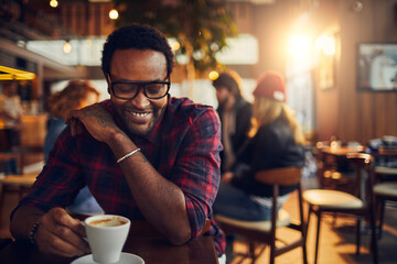 Young man enjoying a cup of coffee in a cafe
