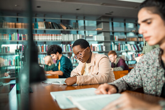 Diverse college students studying in the library