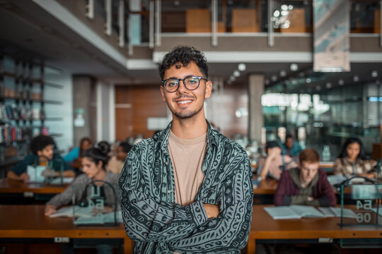 Smiling portrait of a young man in college library