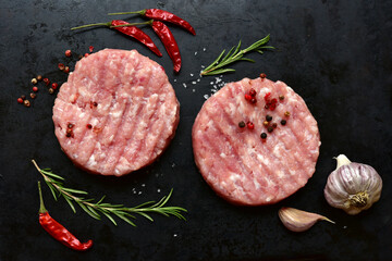 Meat burgers with ingredients for cooking. Top view with copy space.