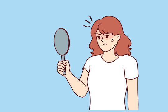 Irritated woman looks in mirror, feeling anger because skin problems or birthmark on face spoiling appearance. Teenage girl is dissatisfied with appearance due to lack proper skincare