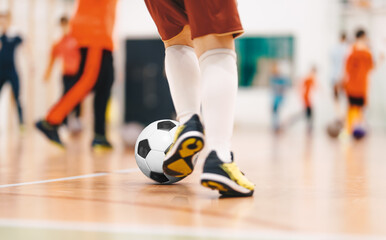 Fototapeta premium Players in Futsal Training. Indoor Soccer Class for Kids at School Sports Hall. Children Kicking Soccer Balls on Wooden Futsal Floor