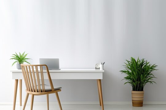 minimalist home office room with wooden table, wooden chair, a laptop, and green leaves plant in white ceramic pot. All in Scandinavian style.