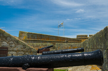 Cannon with the flag of Uruguay in the background - 715801938