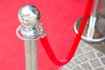 Metal railing stand with red rope for museum or exhibition