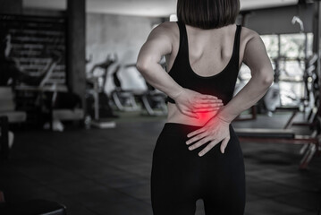 Asian slim woman play fitness at the gym,She pain from exercise