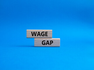 Wage Gap symbol. Concept words Wage Gap on wooden blocks. Beautiful blue background. Business and Wage Gap concept. Copy space.