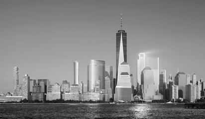 Black and white photo of Manhattan skyline at sunset, New York City, USA.