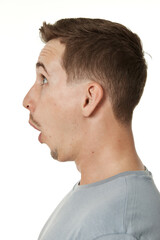 Obraz premium surprised guy looking at camera on white studio background