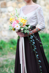 Young bride holding beautiful bouquet