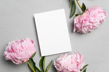 Wedding invitation or greeting card mockup with peony flowers, flat lay with copy space