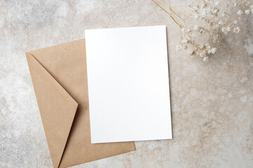 Stylish wedding invitation card mockup with envelope and gypsophila flowers decor, copy space