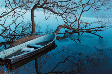 an old rowboat in a lake