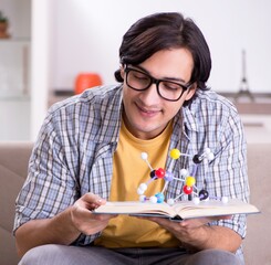 Young student physicist preparing for exam at home