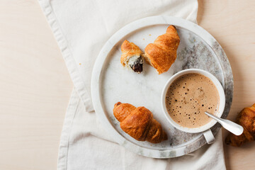 Cup of coffee with croissants.