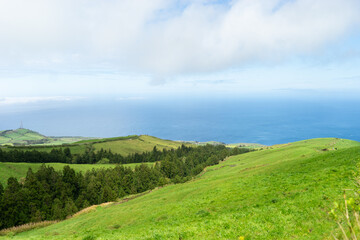 Fototapeta na wymiar green hills against the background of the ocean on the island of Sao Miguel, Azores