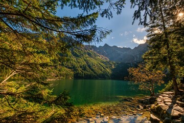 Beautiful, colorful mountain lake with an azure surface and mountain peaks with beautiful sunlight. Morskie Oko - Eye of the Sea - Tatry - Tatra Mountains.Polska Most beautiful places in Poland Polska
