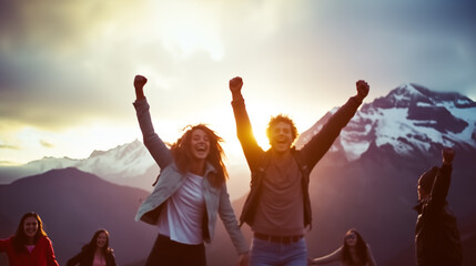 Out of focus image of group of casual teenagers cheering and having a good time in front of sunset mountain landscape - obrazy, fototapety, plakaty
