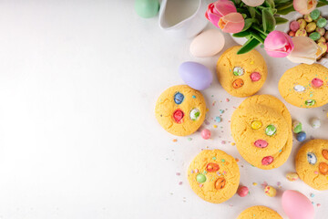 Fototapeta na wymiar Colorful Funfetti chocolate chips mix Cookies. Homemade sweet Easter vanilla biscuits with sugar sprinkles and chocolate Easter eggs, on white kitchen table background, with holiday decor