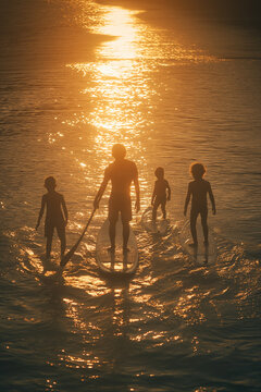 family standing on a surfboard in the ocean summer concept