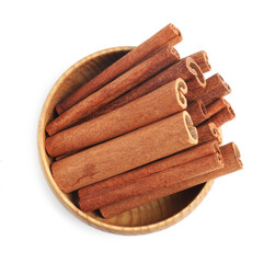 Aromatic cinnamon sticks in bowl isolated on white, top view