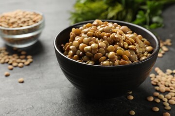 Delicious lentils in bowl on grey table, closeup