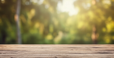Fototapeta premium Warm sunlight filters through a blurred forest scene behind a smooth, empty wooden table surface. 