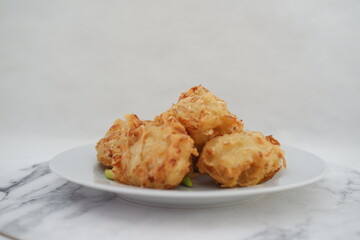 Bakwan sayur or vegetable fritter, Indonesian snack made from flour, cabbage, carrots and bean sprouts, served with chili