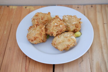 Bakwan sayur or vegetable fritter, Indonesian snack made from flour, cabbage, carrots and bean sprouts, served with chili