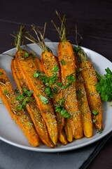 baked carrots on a plate on a brown background
