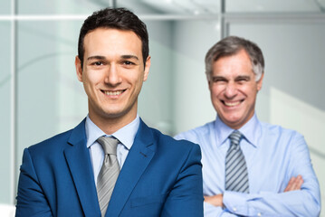 Confident businessmen smiling in office