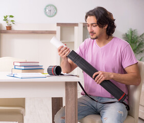 Young male architect student preparing for exams at home