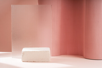 Podium for exhibitions and product presentations, material: stone, wood, glass, dry branches. Beautiful beige peach background made from natural materials. Abstract nature scene with composition.